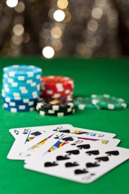 Live Boom City studio with professional dealer and game cards displayed on mobile phone screen